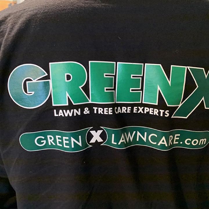 The GreenX Lawn and Tree Care logo screen printed across the back of a black tee