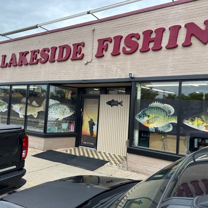 A storefront with red dimensional letters and full-color fish on the windows