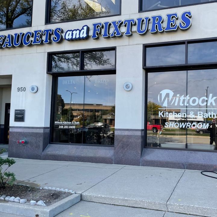 Blue Faucets and Fixtures letters over a Wittock Kitchen and Bath showroom window