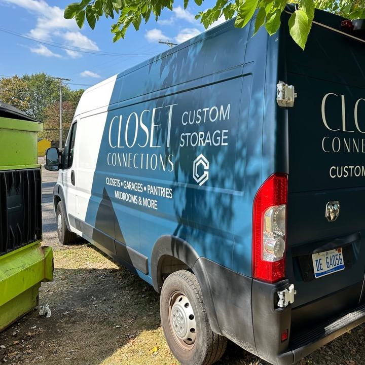 A van wrapped in slate blue and black with the Closet Connections logo