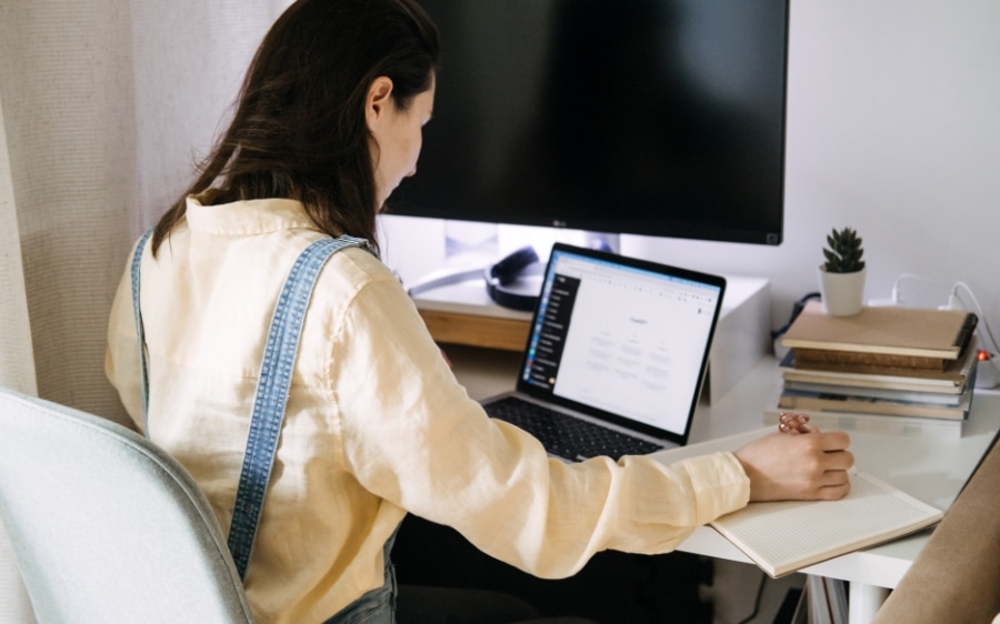 A business owner at her desk with an AI assistant open on the screen