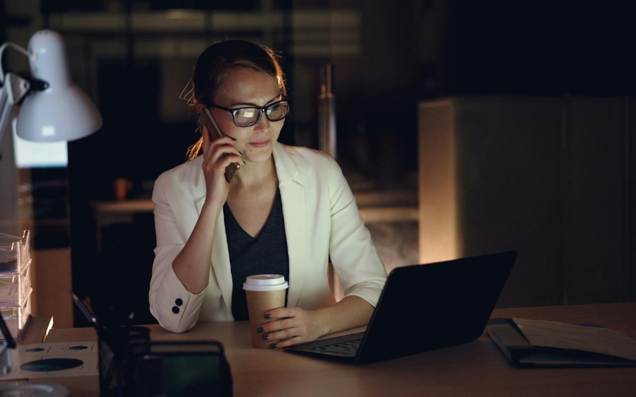 A business owner on the phone at her desk, taking a call