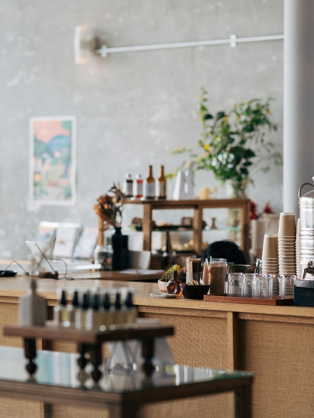 A coffee shop counter with the menu on the wall